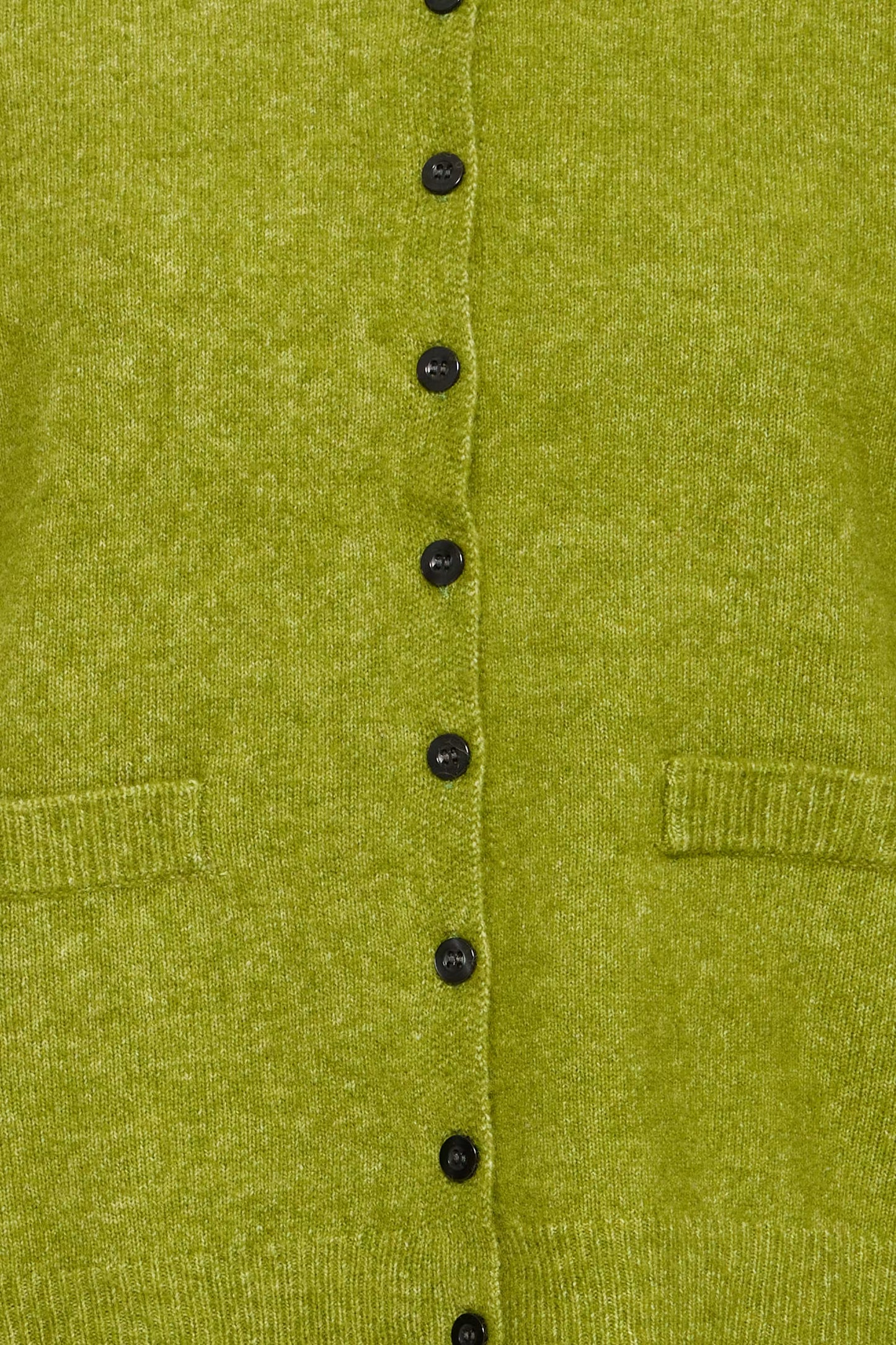 Close-up of a textured olive green knit cardigan featuring a vertical row of black buttons and two front patch pockets.