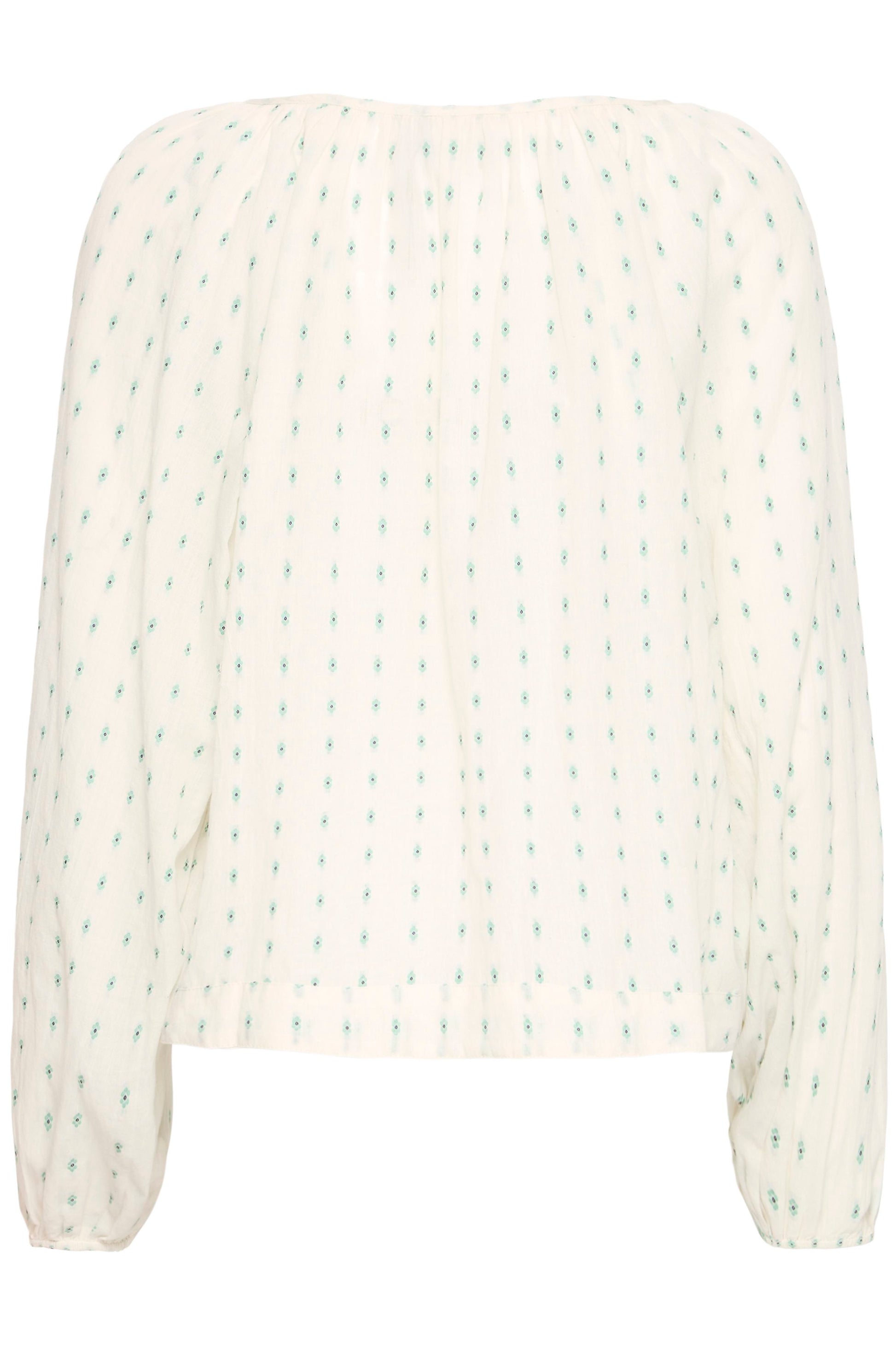 White blouse with green pattern on a white background