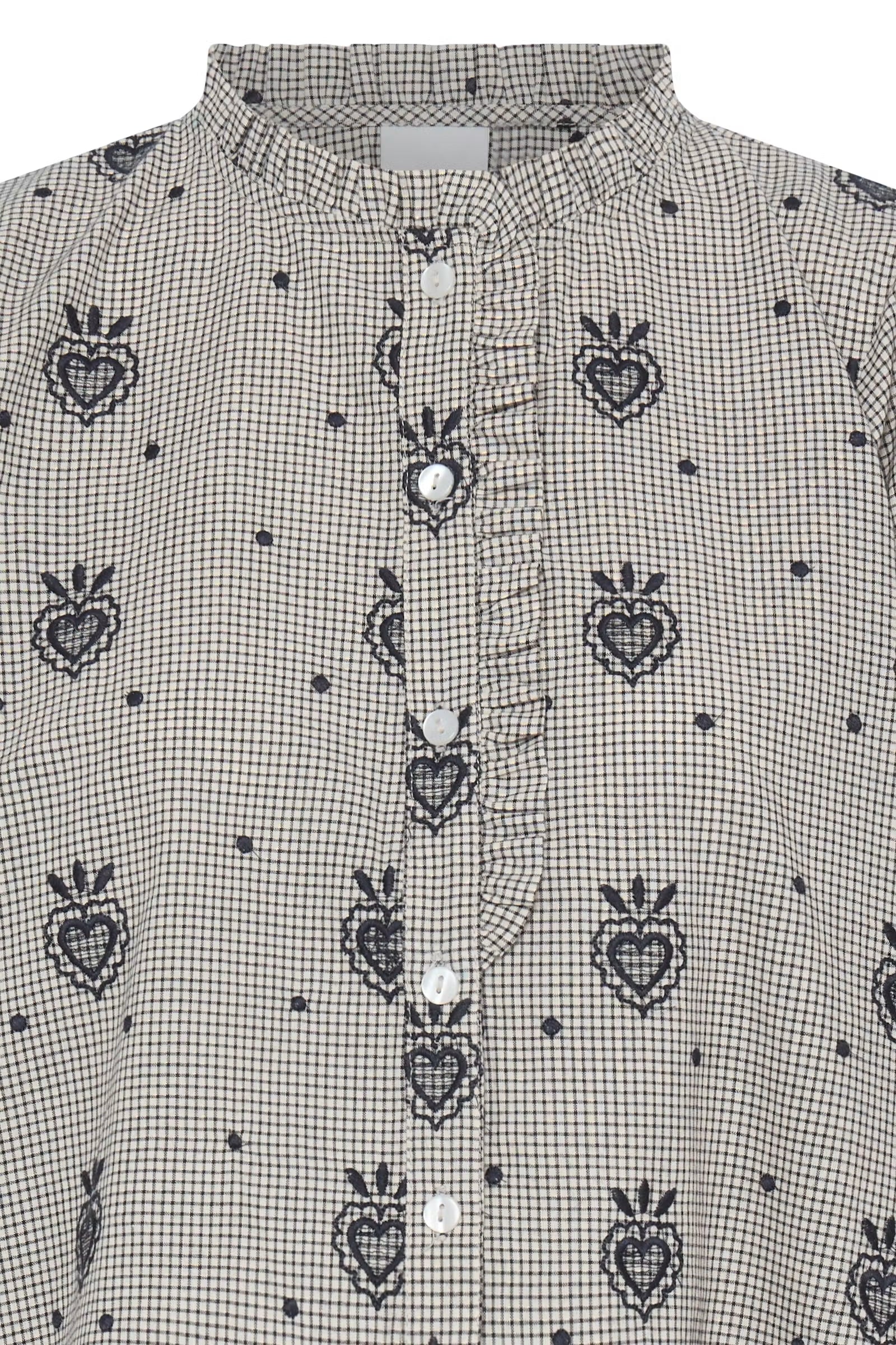 a gray long-sleeve blouse with a repeating dark blue embroidered heart and crown motif