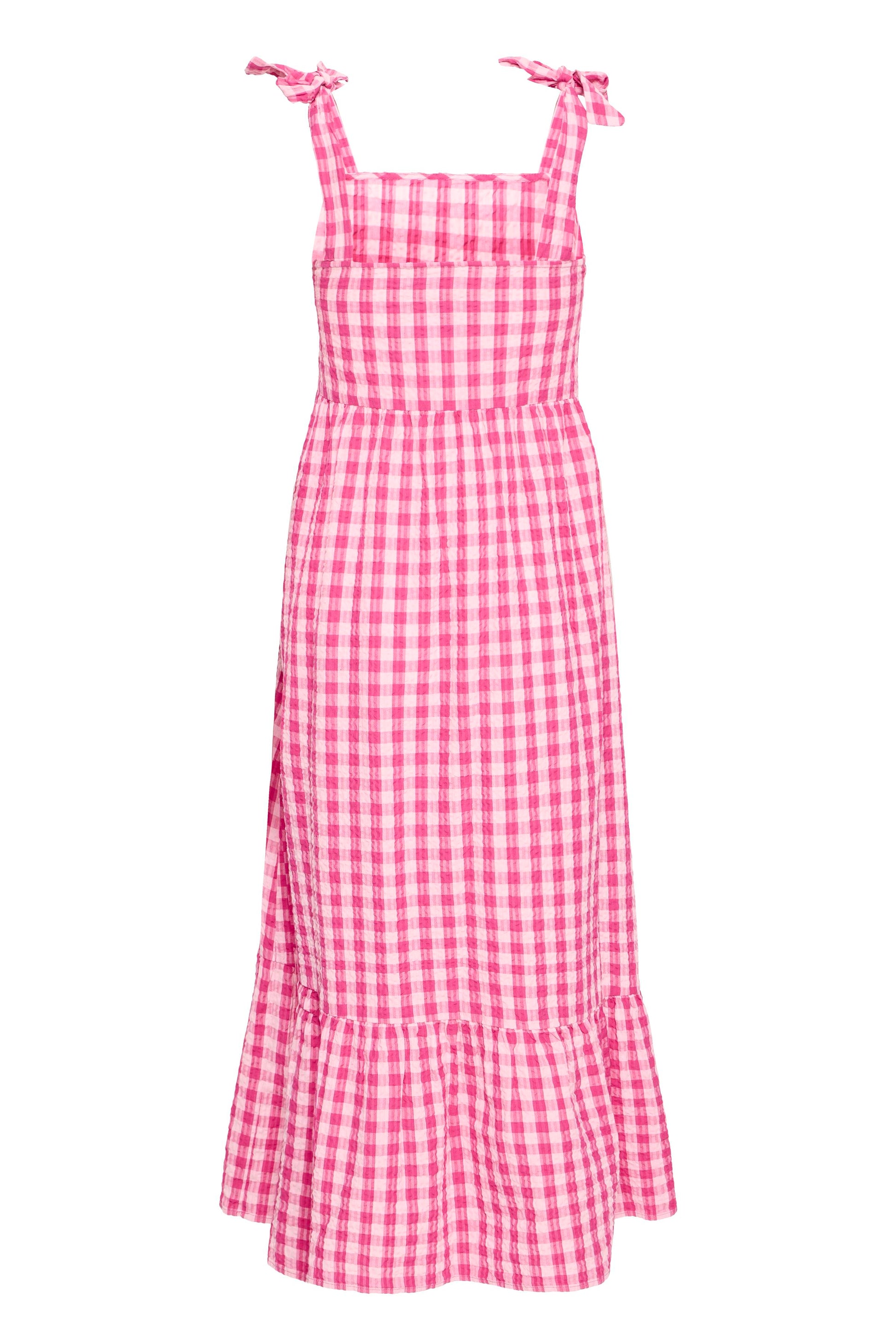 Pink and white checkered dress with ruffled hem on a white background