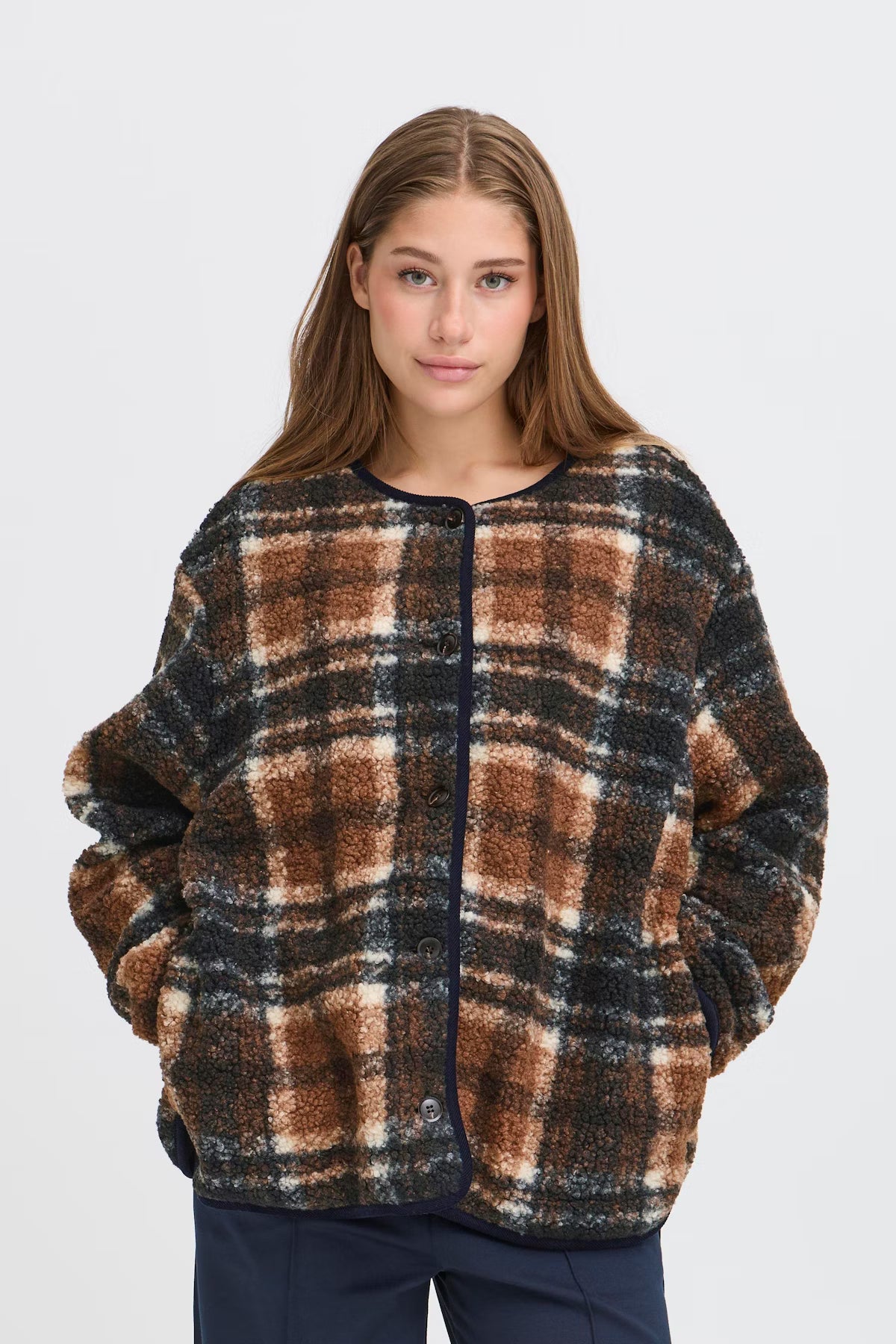 Woman wearing a plaid sweater on a white background