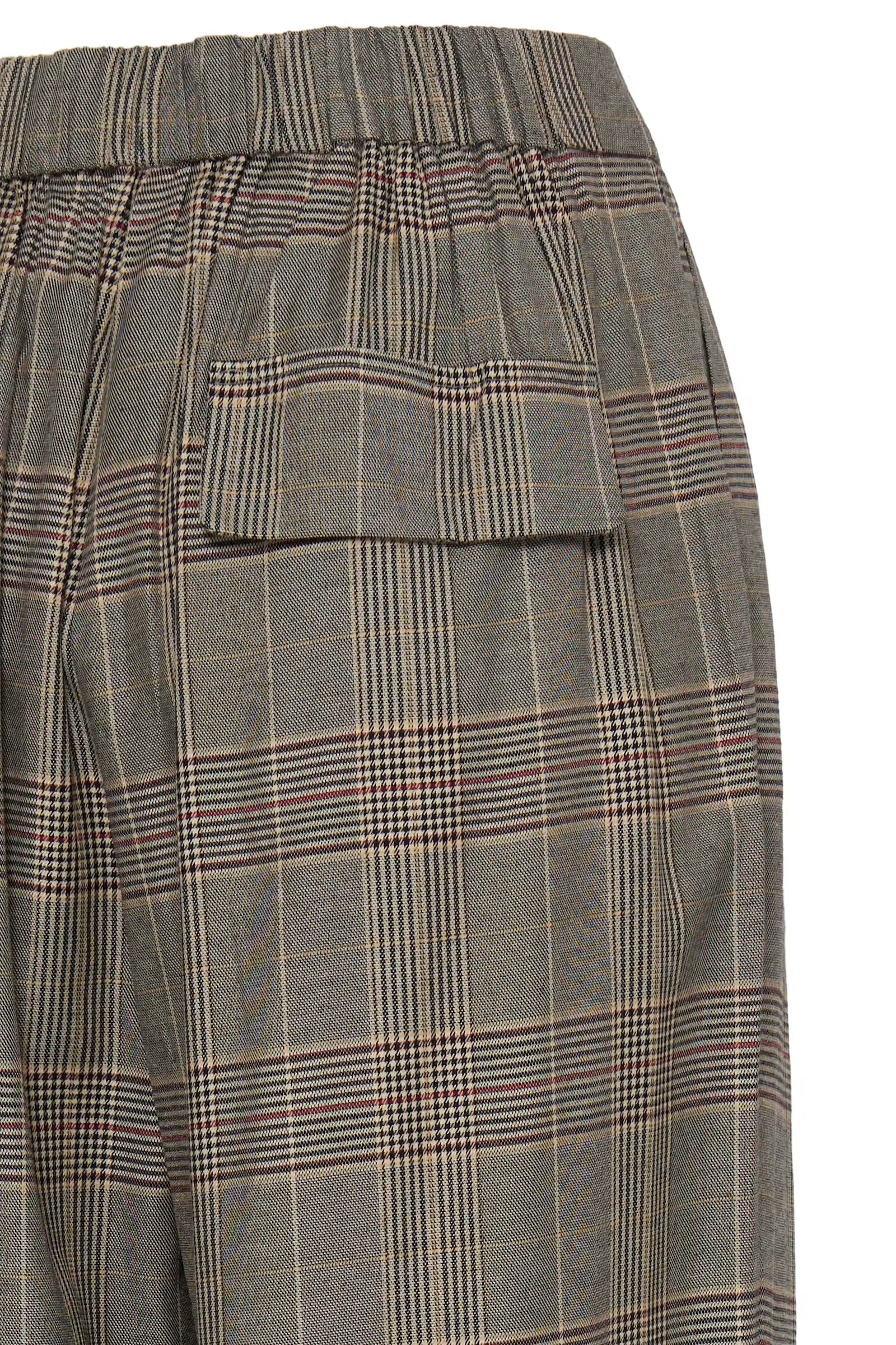 Close-up of a pair of plaid trousers showing the back pocket and elastic waistband. The fabric features a muted gray-green base with thin black, beige, and red windowpane lines.