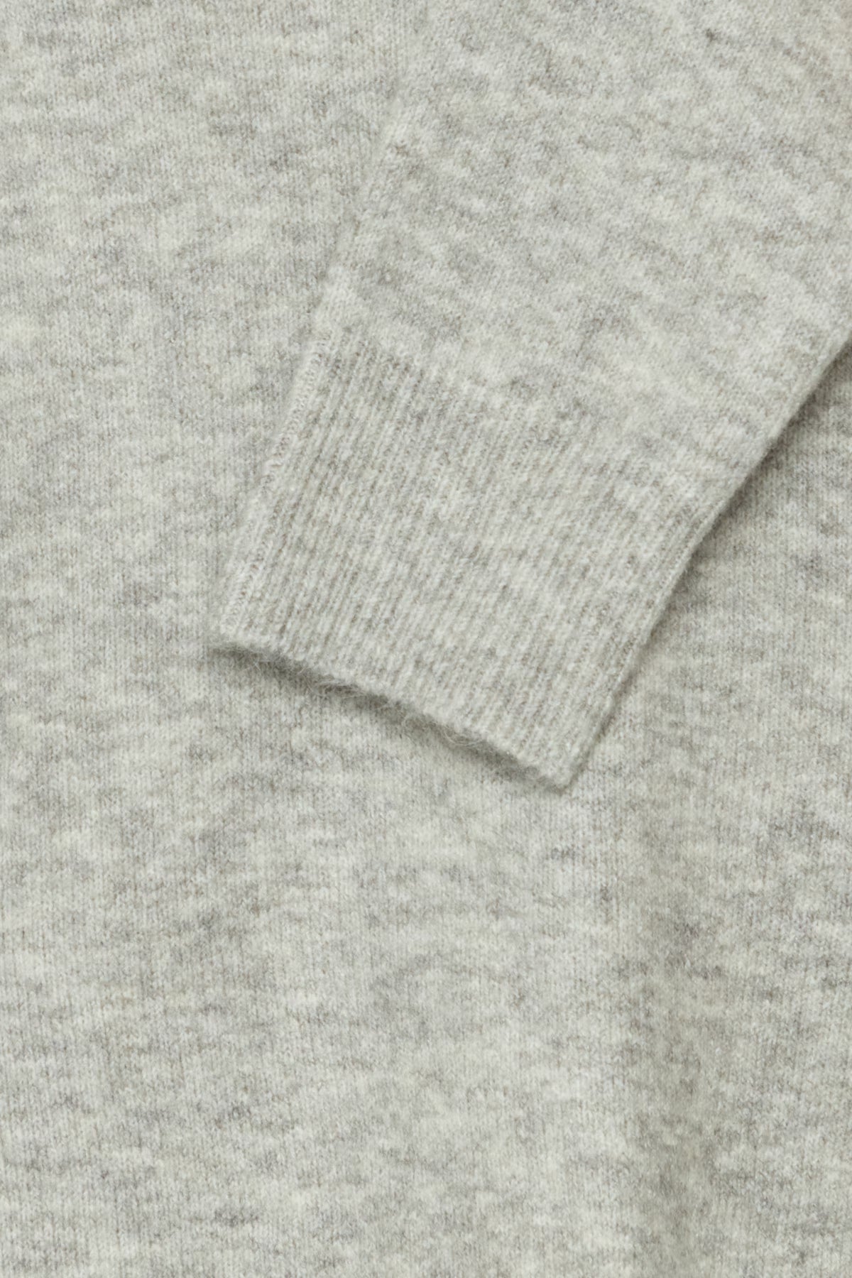 Close-up of a gray sweater with a ribbed texture