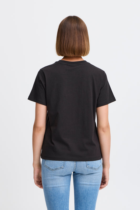 Person wearing a black t-shirt and blue jeans on a light gray background