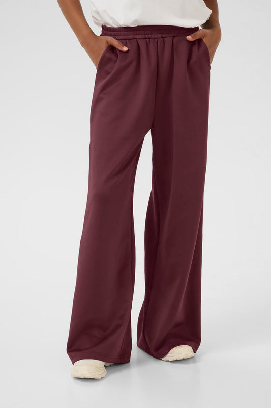 Maroon wide-leg pants worn by a person on a white background