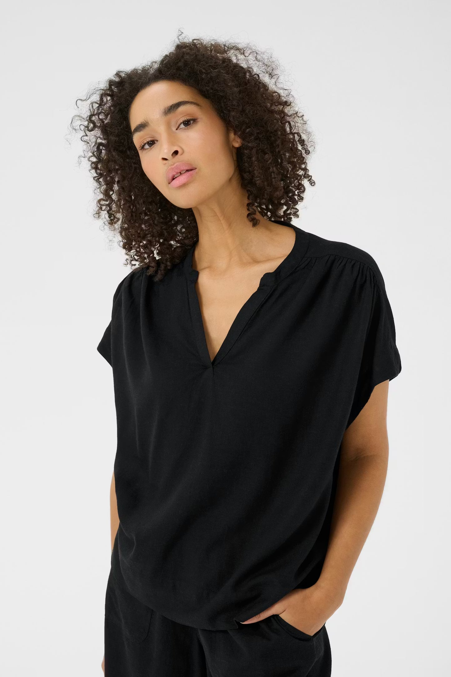 Woman wearing a black top against a white background