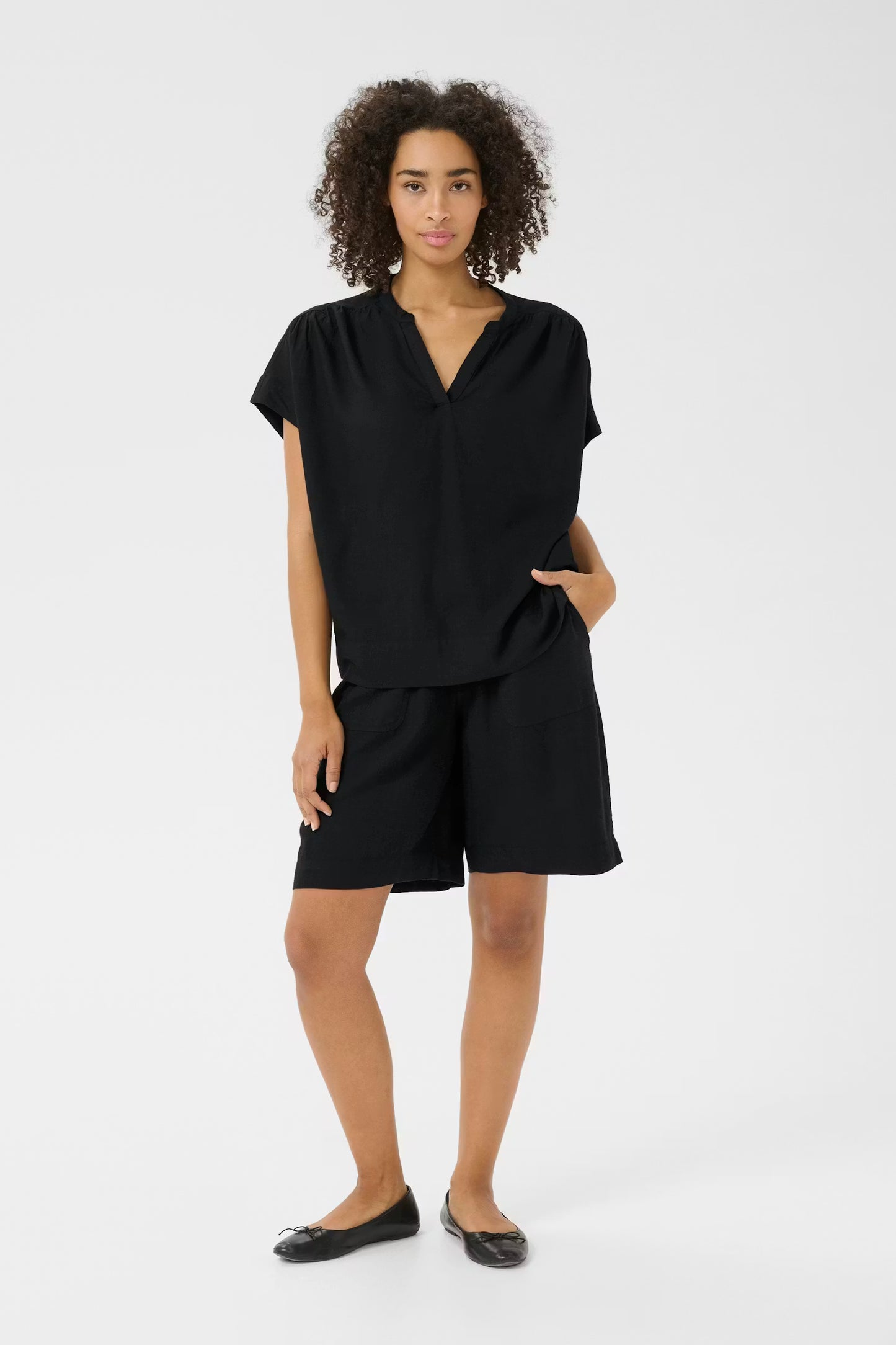 Woman wearing a black outfit on a white background