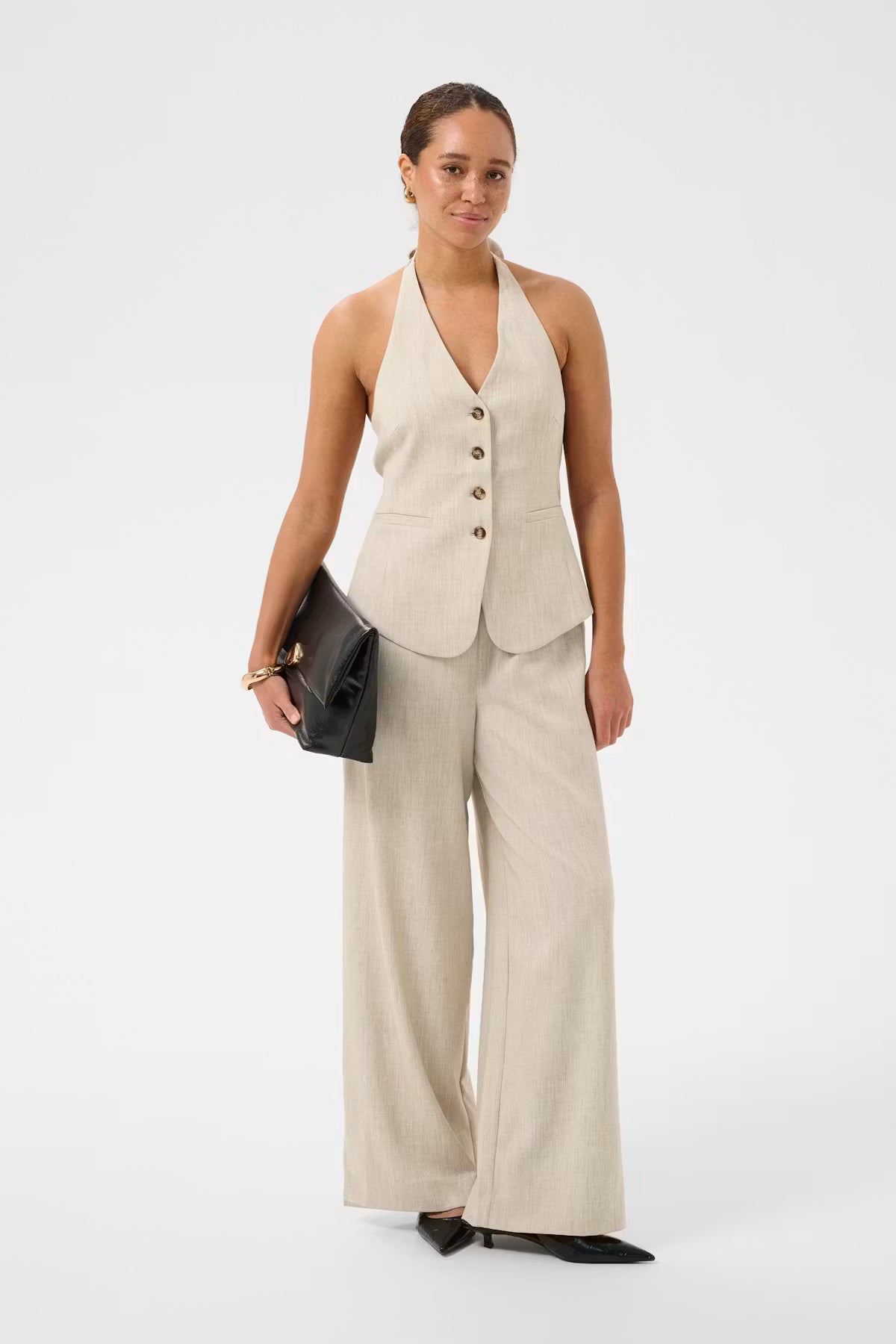 Woman wearing Beige top and trousers on white background