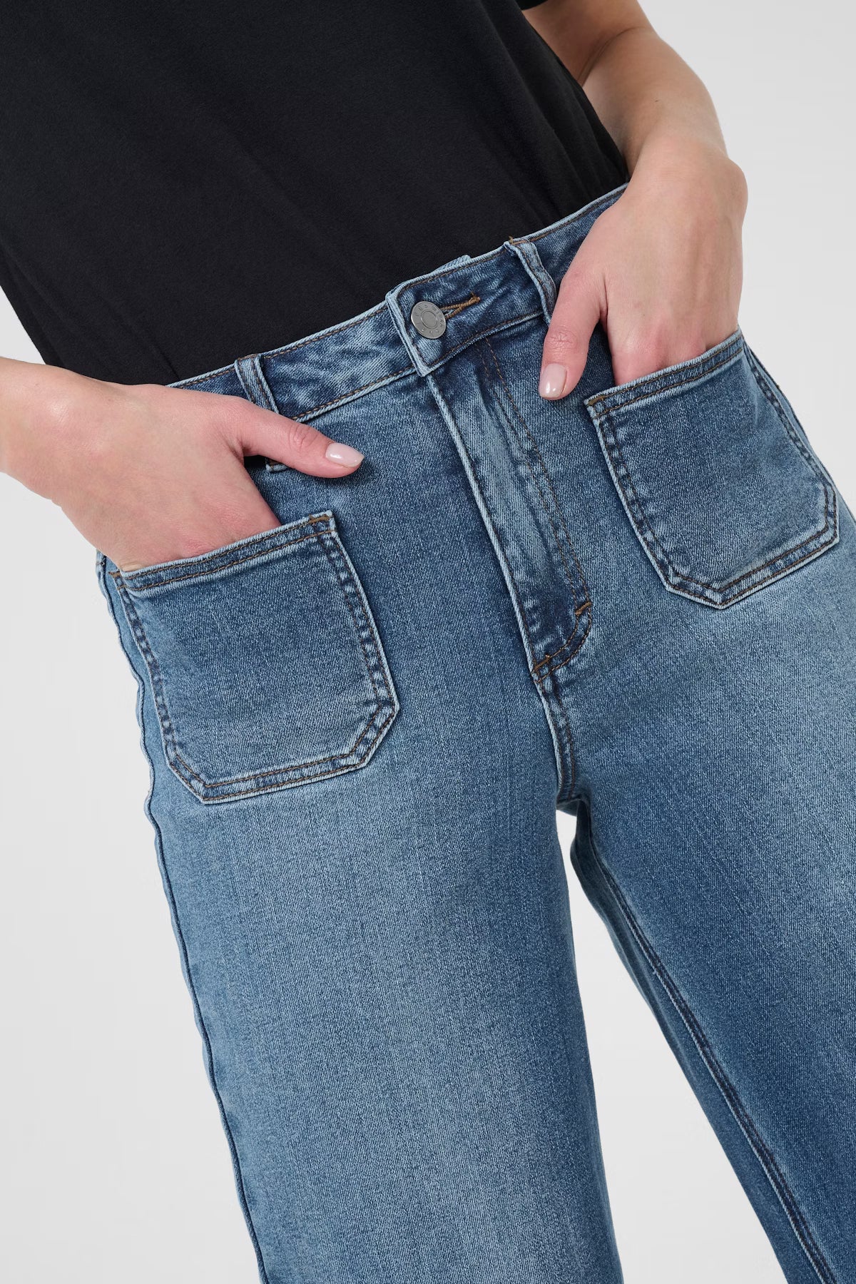 Close-up of blue jeans with a plain background