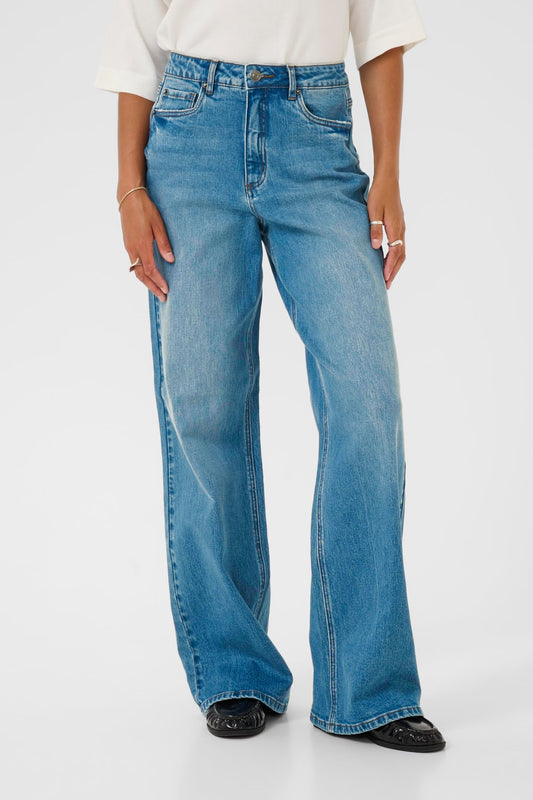 Person wearing blue jeans on a white background