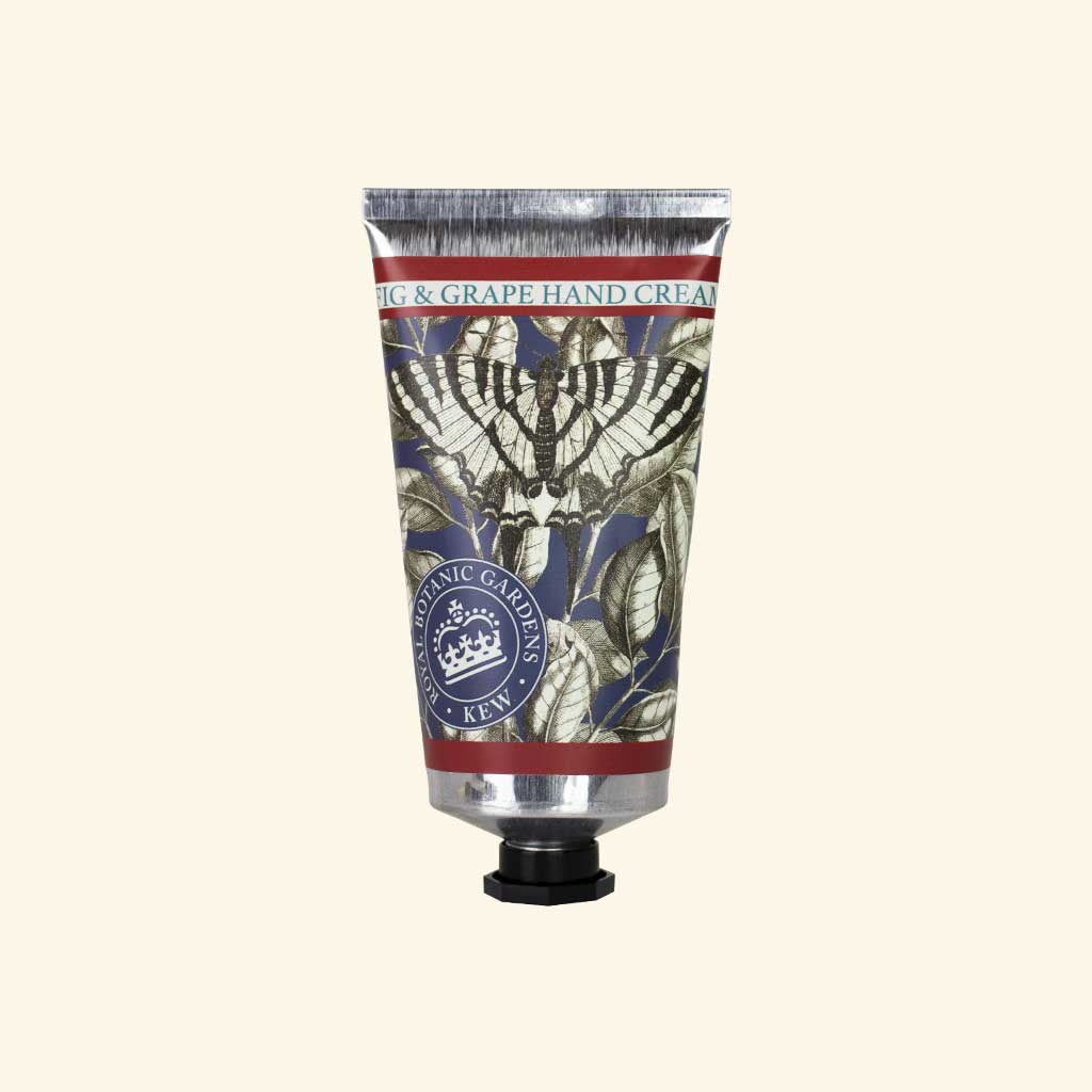 Hand cream tube with decorative label on a beige background