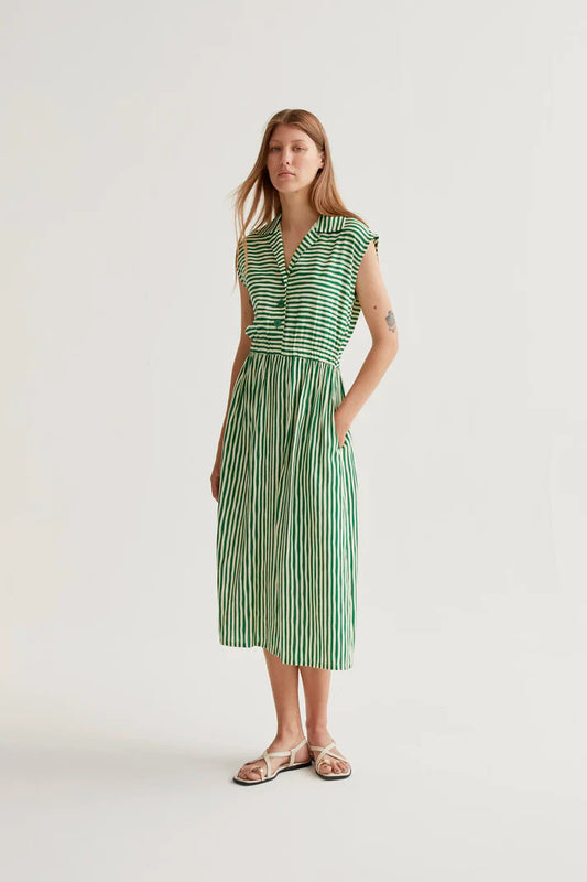 Woman wearing a green and white striped dress on a white background