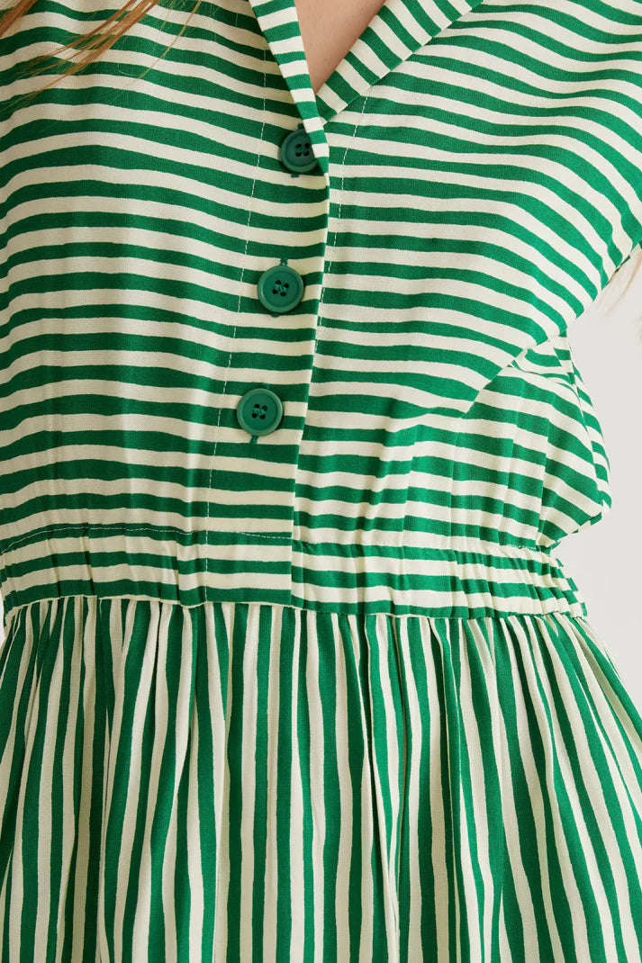 Green and white striped dress with buttons on a plain background