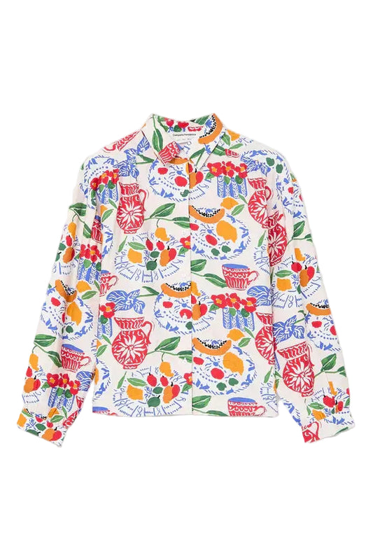 Colorful floral and fruit patterned shirt on a white background