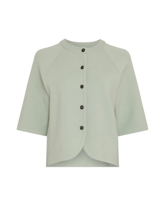 light green cardigan on light grey backgound