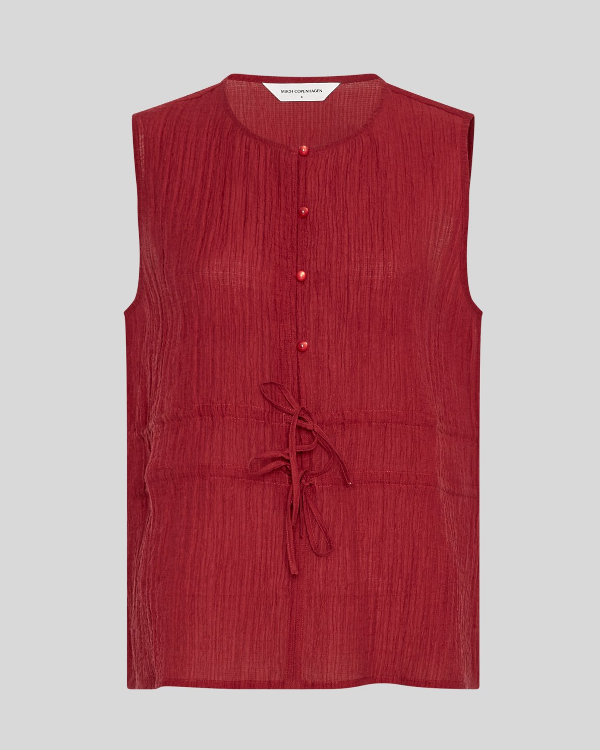 Red sleeveless blouse on a neutral background