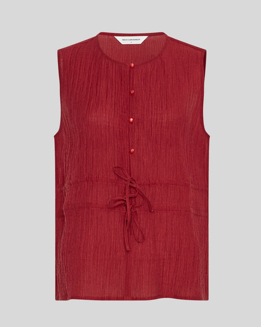 Red sleeveless blouse on a neutral background