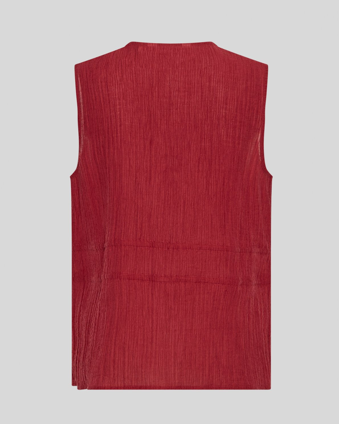 Red sleeveless blouse on a neutral background