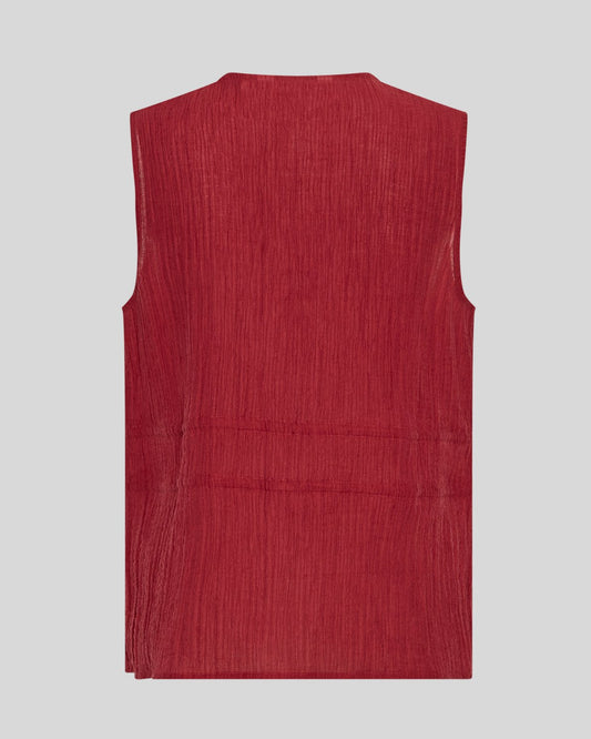Red sleeveless blouse on a neutral background