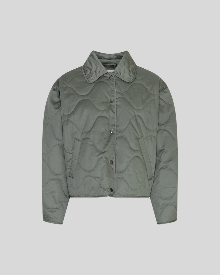 Green quilted jacket on a light gray background