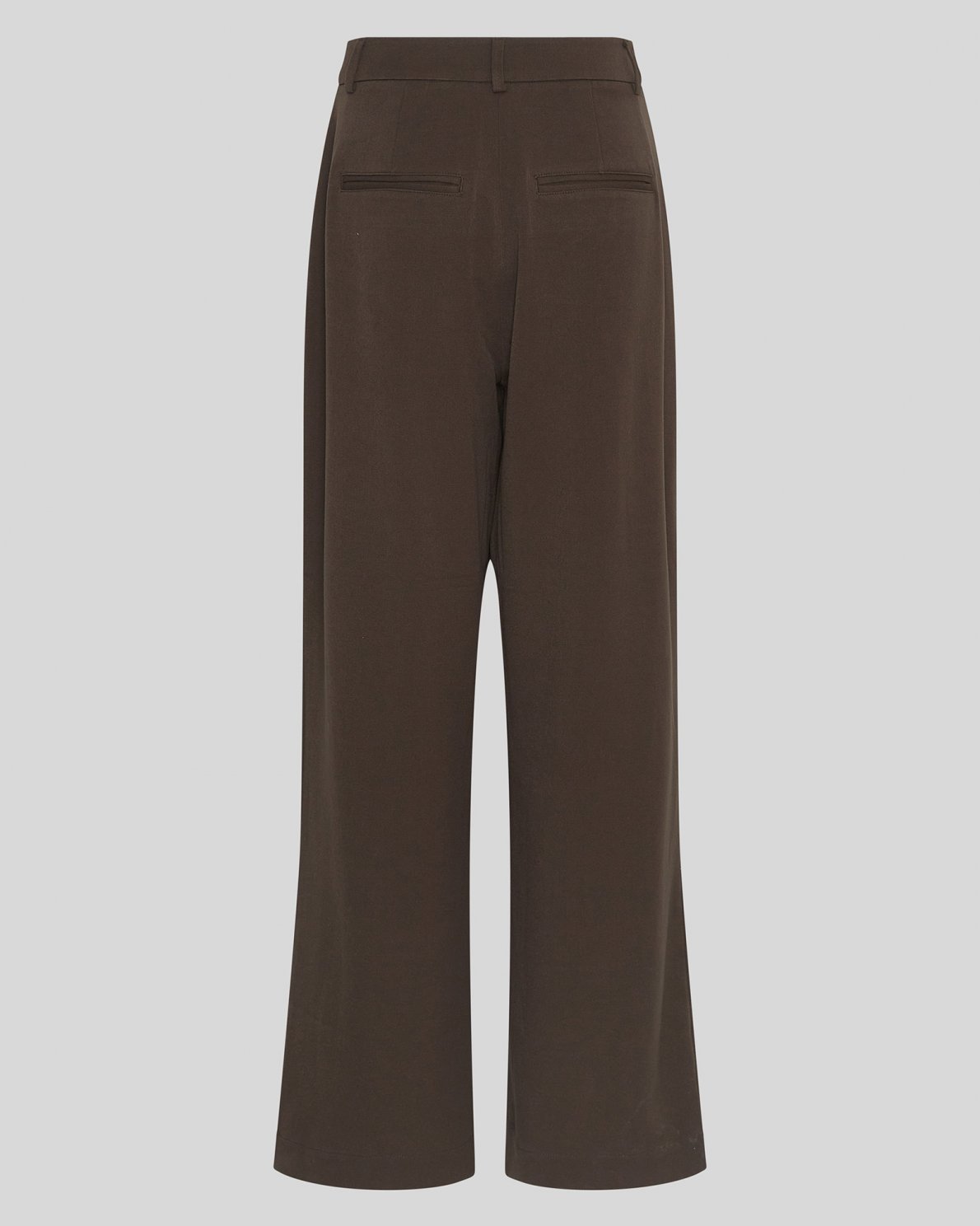 A pair of dark brown wide-leg trousers shown from the back, featuring two welt pockets and a high waistband, set against a solid light gray background.