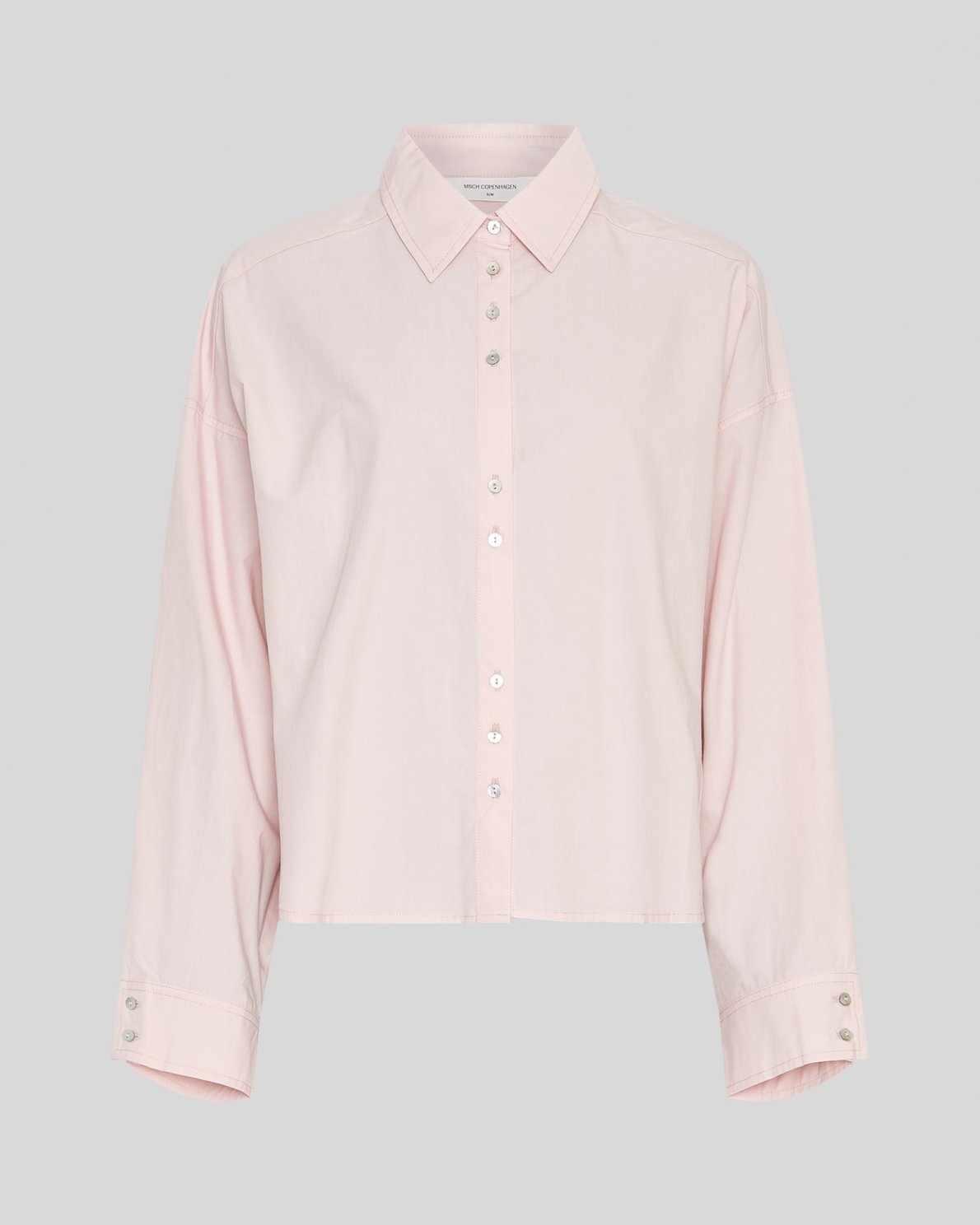 Light pink shirt on a neutral background