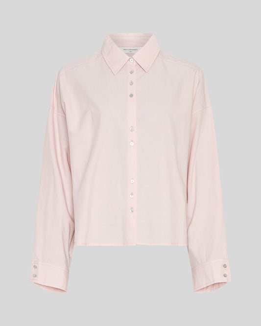 Light pink shirt on a neutral background