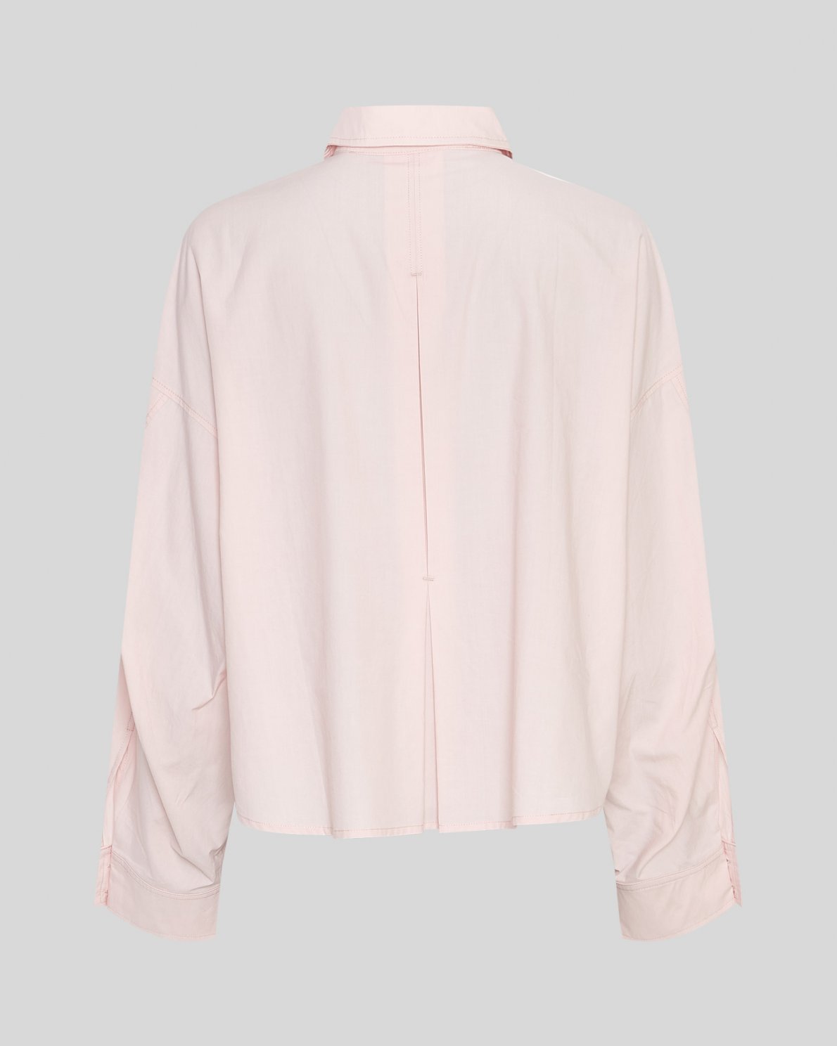 Light pink shirt on a neutral background