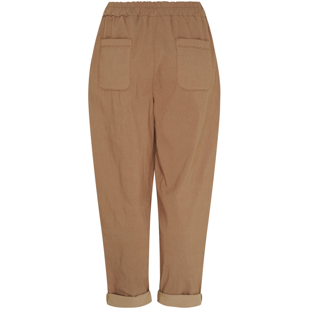A pair of women's cropped trousers in a warm tan or camel color, featuring an elastic waistband, two large patch pockets on the back, and rolled cuffs, shown against a plain white background.