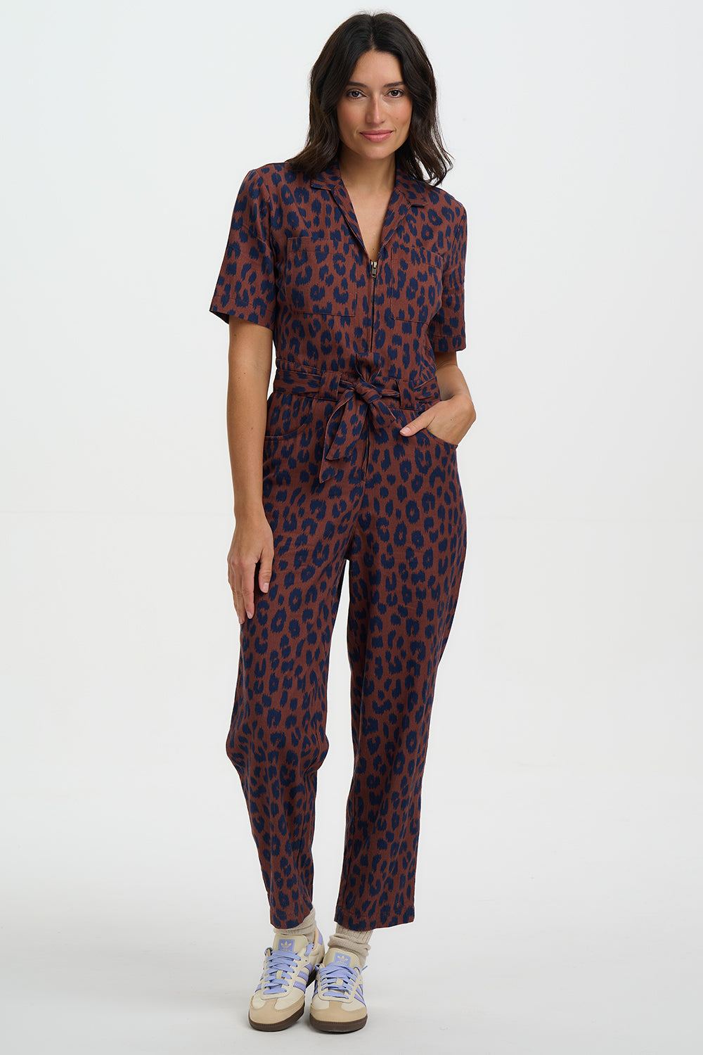 Woman wearing a patterned jumpsuit on a white background