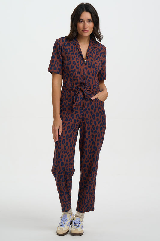 Woman wearing a patterned jumpsuit on a white background