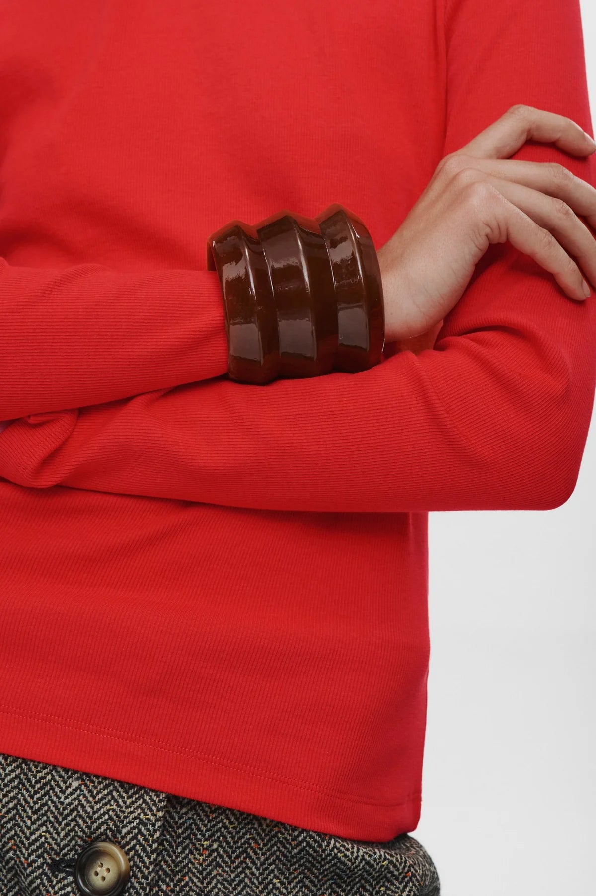 Red garment with brown cuffs on a white background