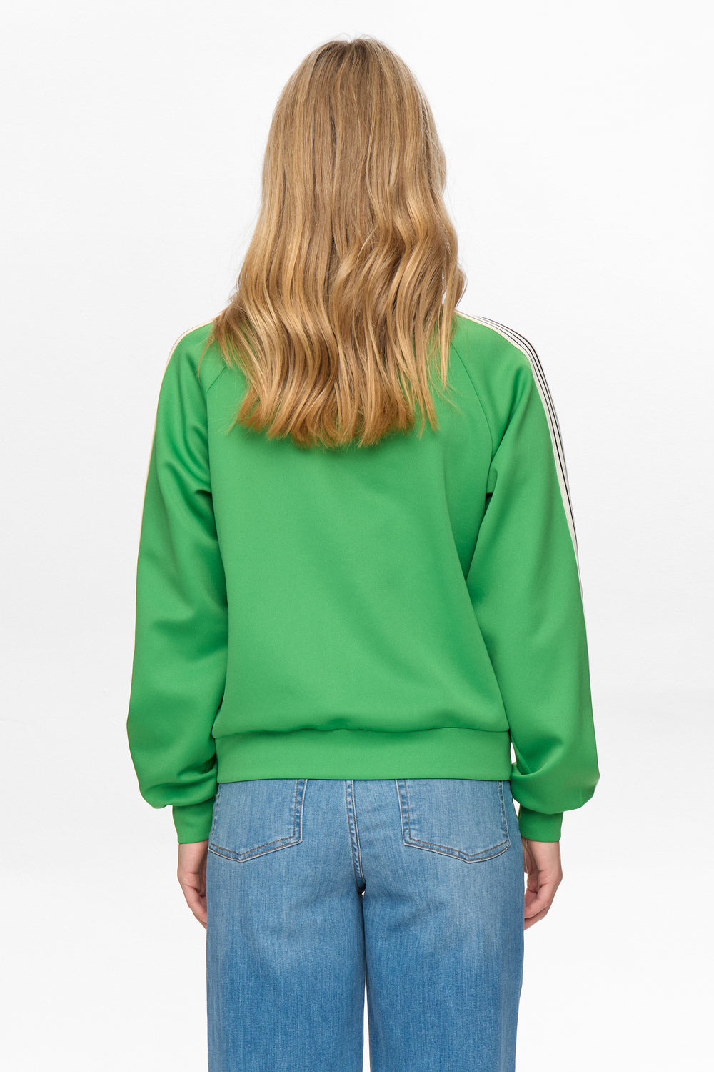 Person wearing a green sweatshirt with white stripes on a white background