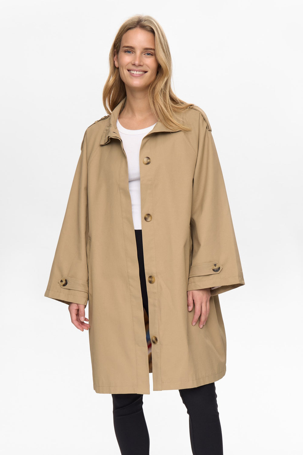 Woman wearing a beige trench coat on a white background