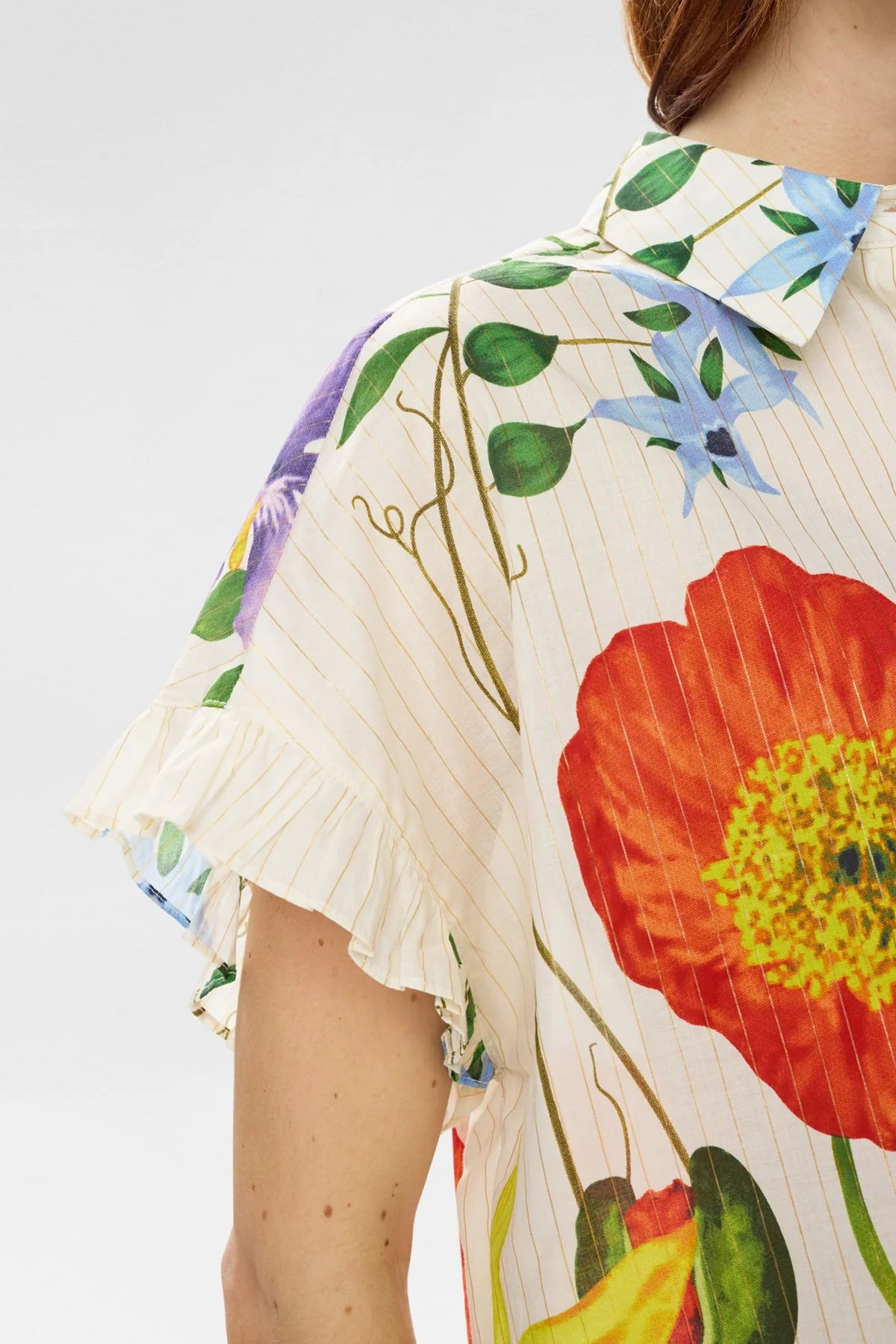 close up of a Floral short sleeve blouse with floral detail on a white background