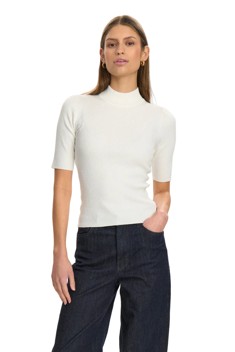 Woman wearing a white short-sleeve top and dark pants on a white background