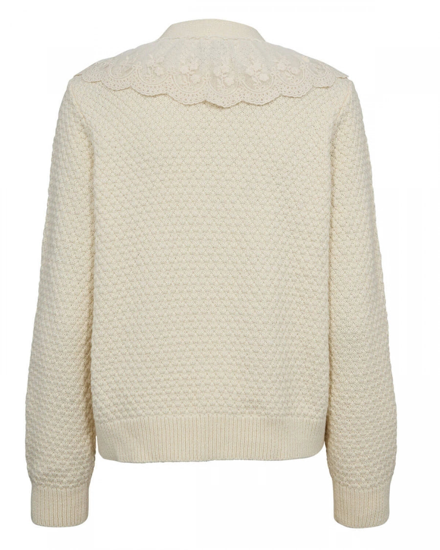 Cream-colored cardigan with lace details on a white background