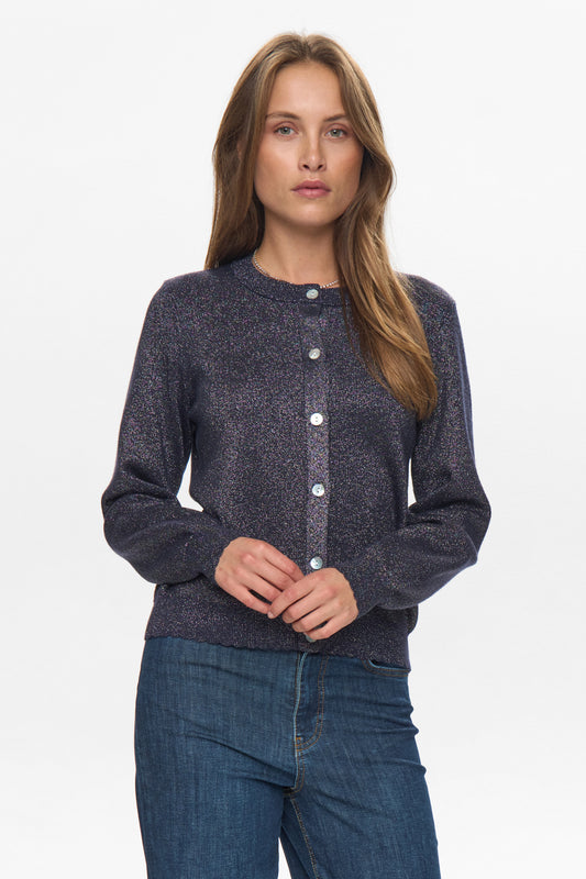 Woman wearing a dark blue cardigan with buttons on a white background