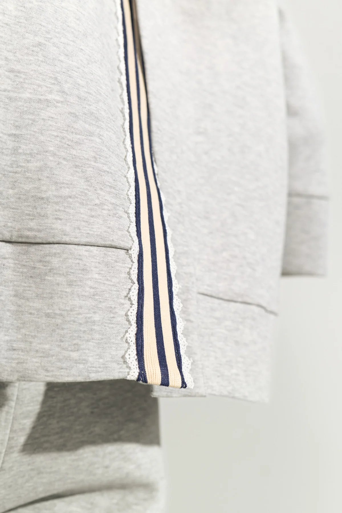 Gray sweatshirt with a striped trim on a light background