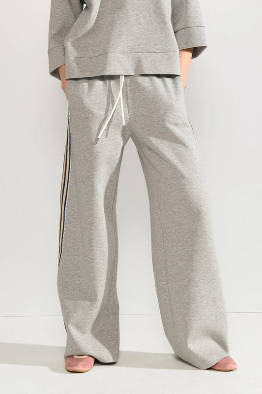grey joggers with a black embroidered striped outer seam on a neutral background