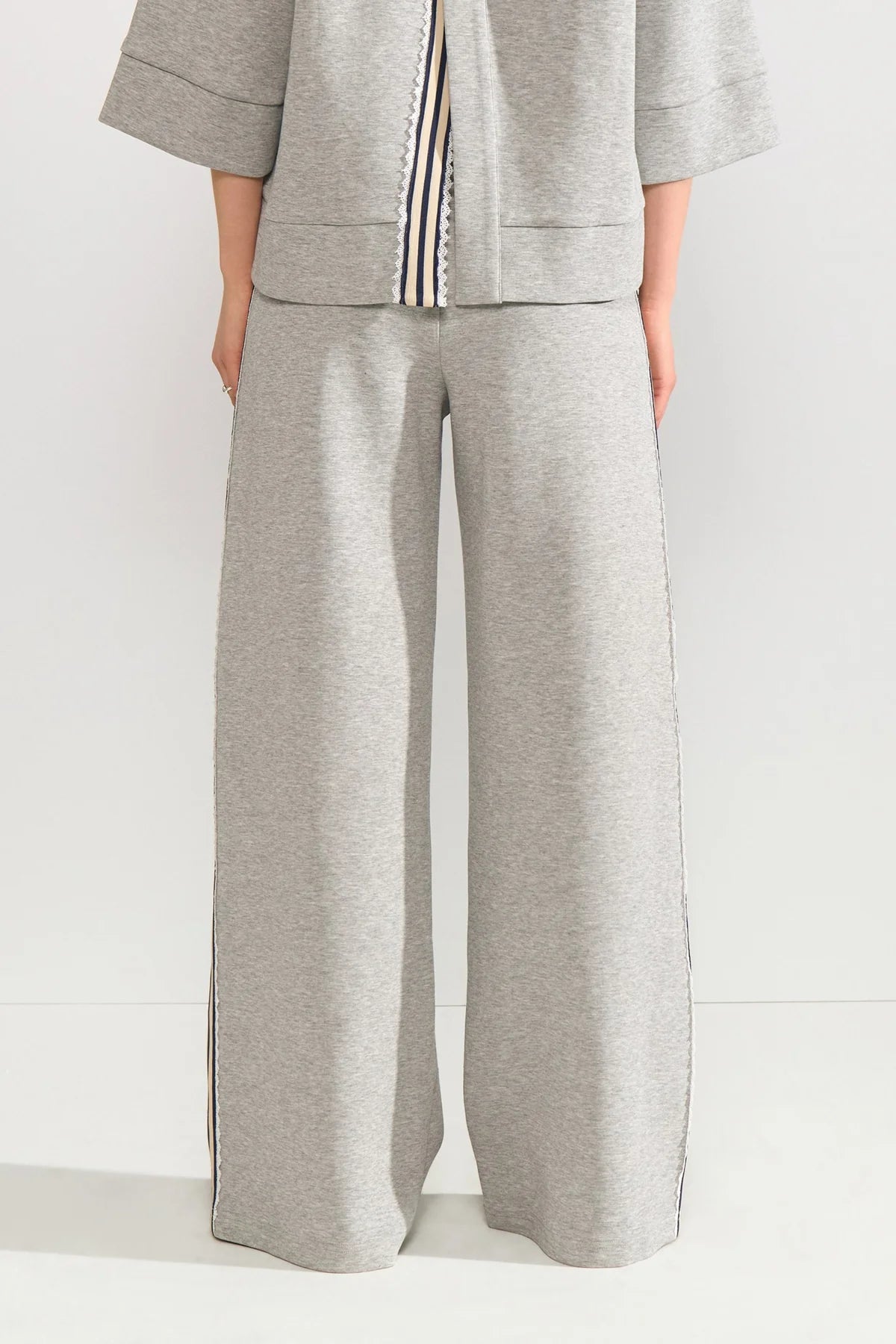 Gray outfit with wide-leg pants and a jacket on a white background
