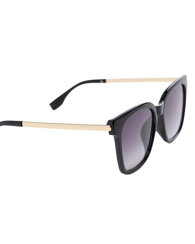 Black sunglasses with gold frames on a white background