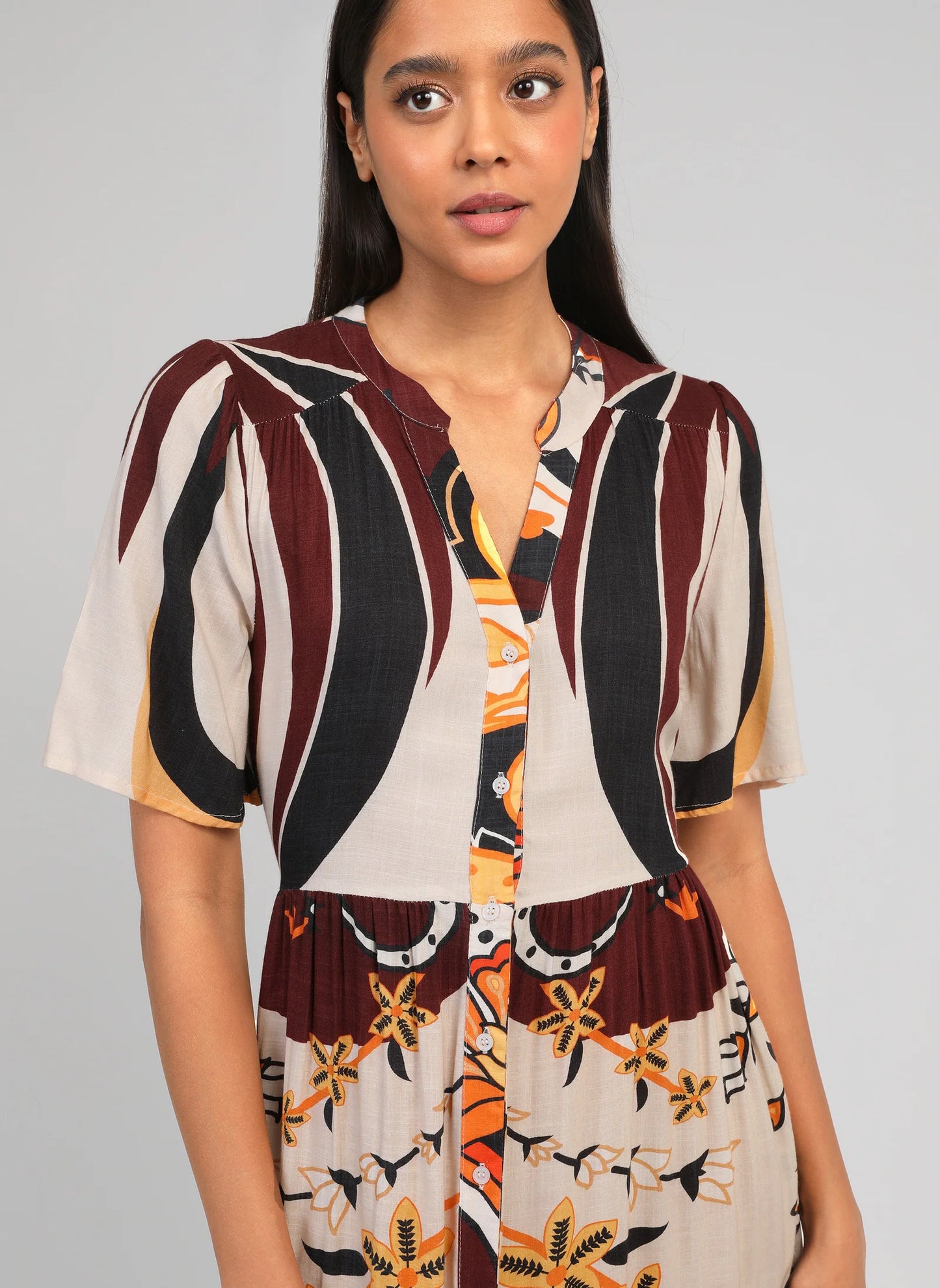 Woman wearing a patterned outfit with a plain background