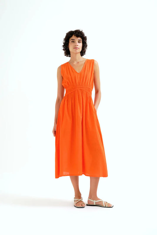 woman wearing an orange dress on a white background