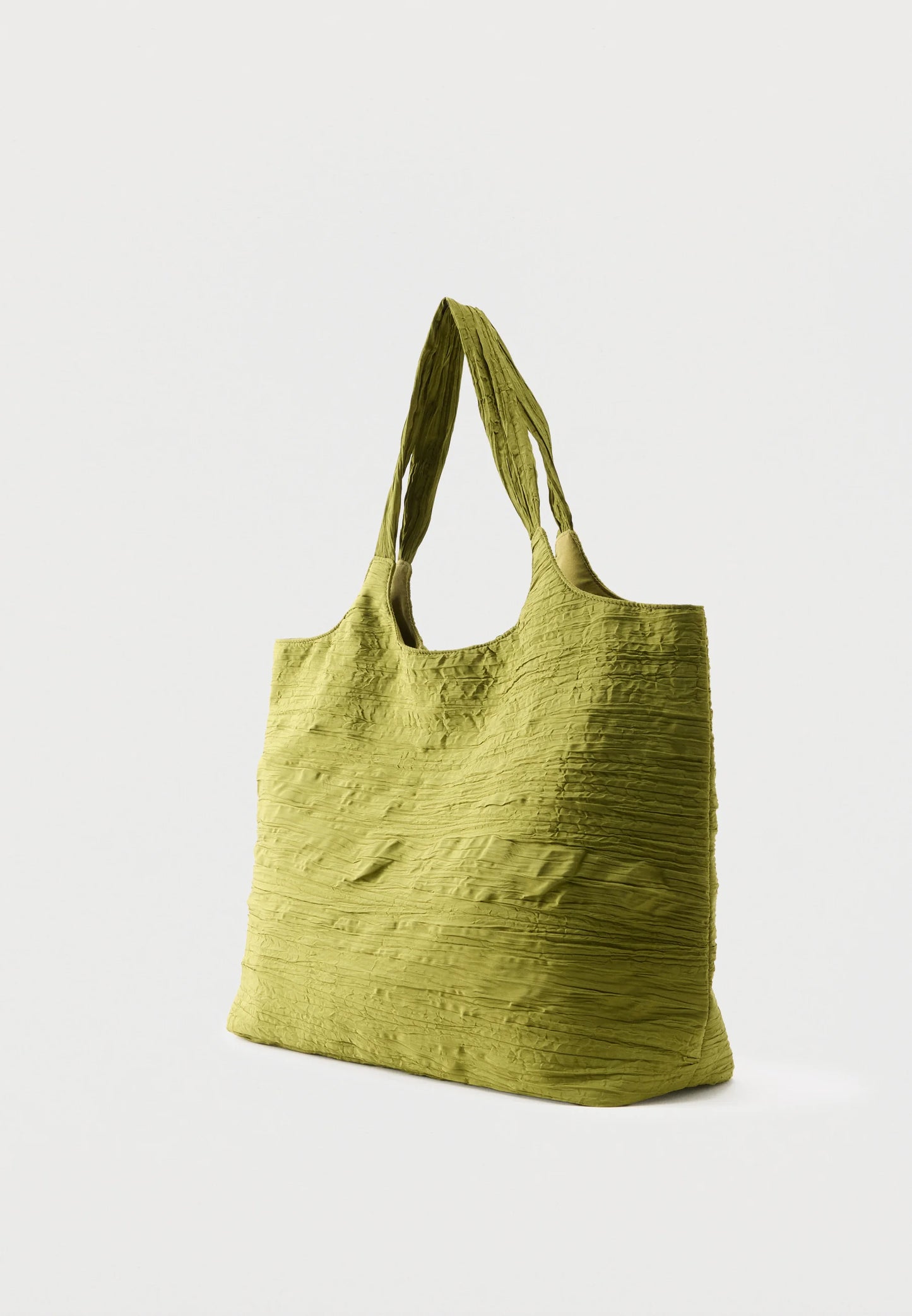 A textured olive green fabric tote bag with two shoulder straps, shown from a three-quarter angle against a light gray background.