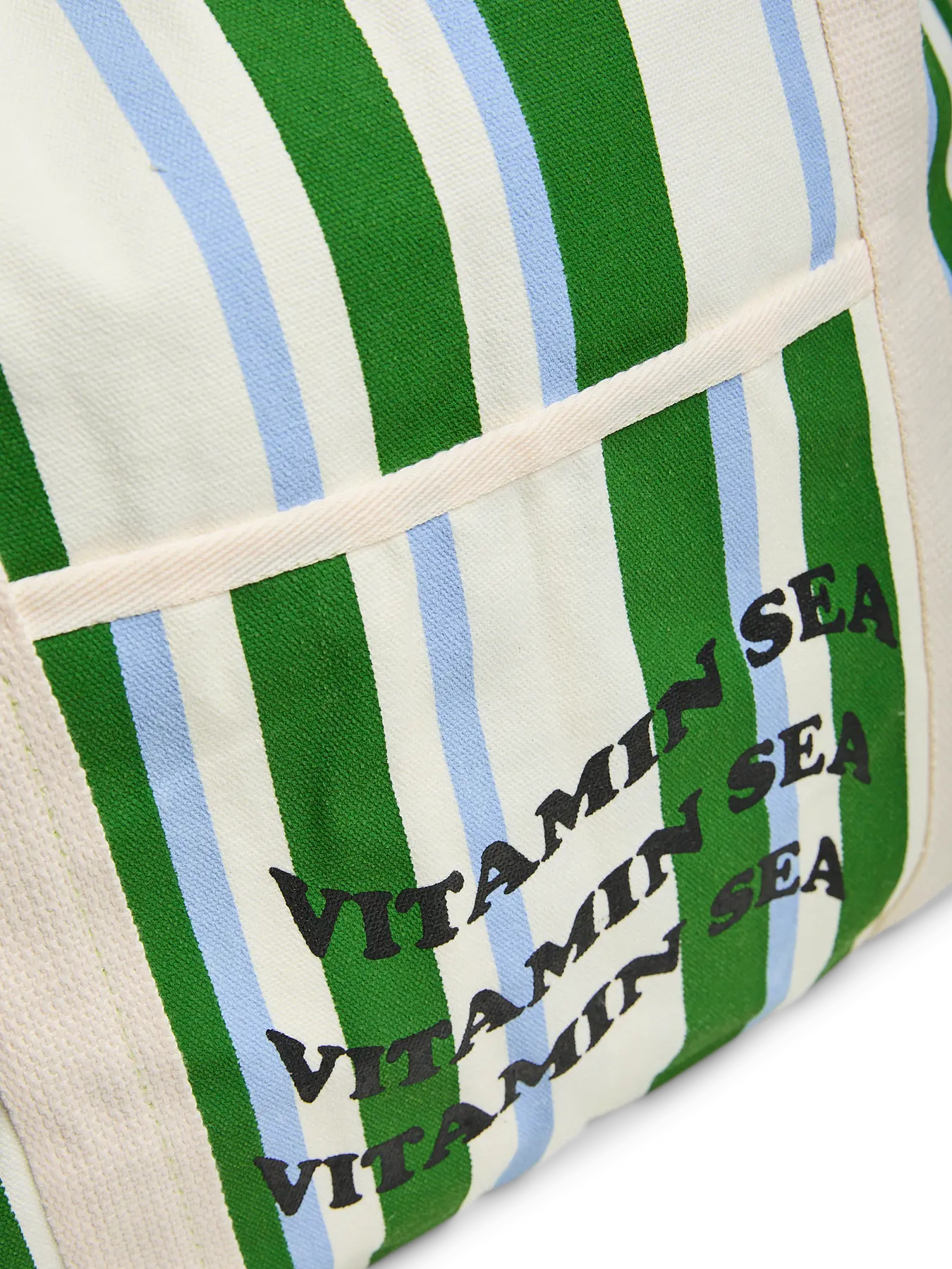 Textile product with green, blue, and white stripes and 'Vitamin Sea' text.
