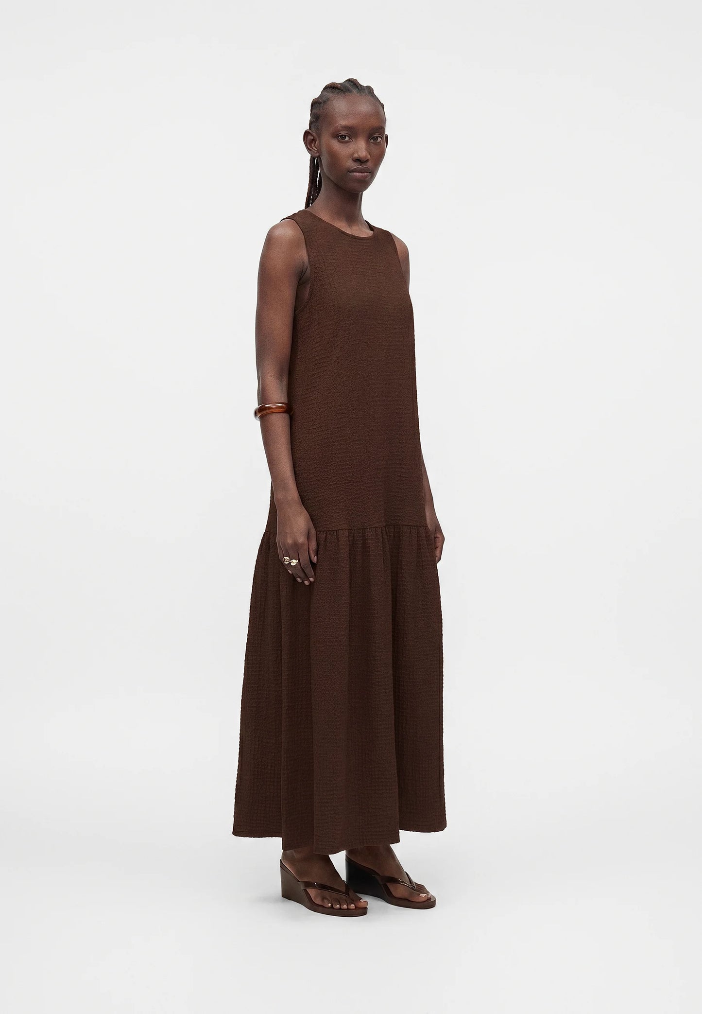 Woman wearing a brown dress on a white background