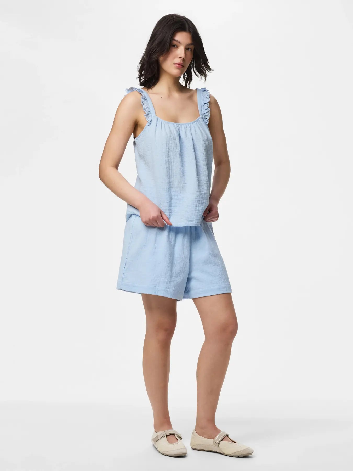 Woman wearing a light blue dress on a white background
