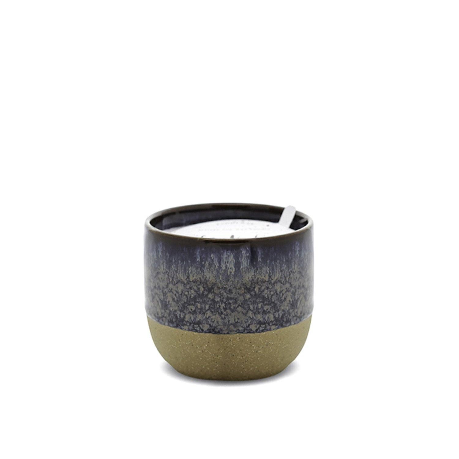 Ceramic candle holder with a dark top and light bottom on a white background