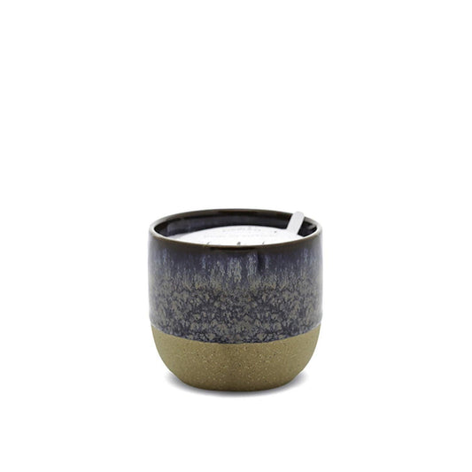 Ceramic candle holder with a dark top and light bottom on a white background